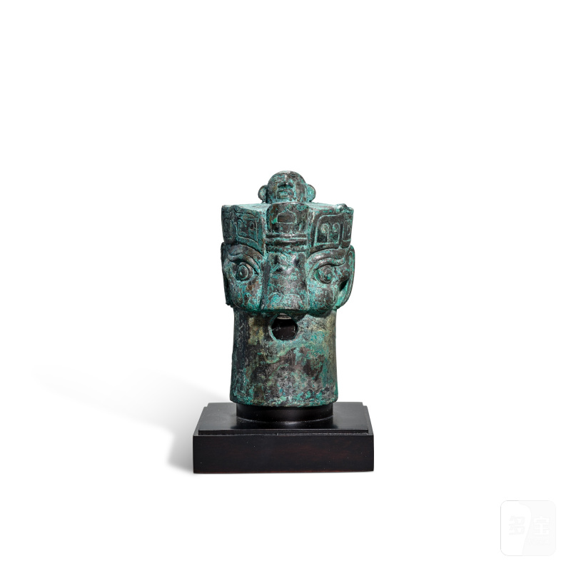 An archaic bronze 'tiger and figure' chariot fitting, Western Zhou dynasty | 西周 青銅虎面人身車穀